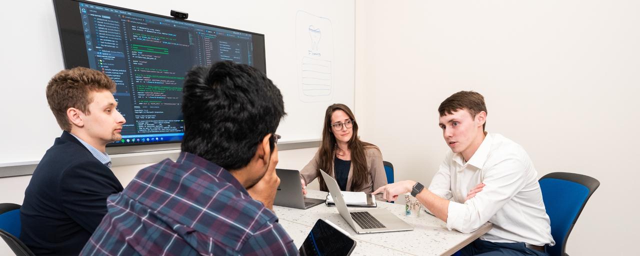 Developers collaborating in a meeting.